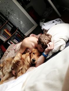 Boy, sleeping with a Golden Retriever